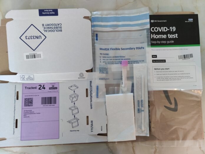 COVID Home Testing Kit PCR UK - a box of medicine and a package of vaccine